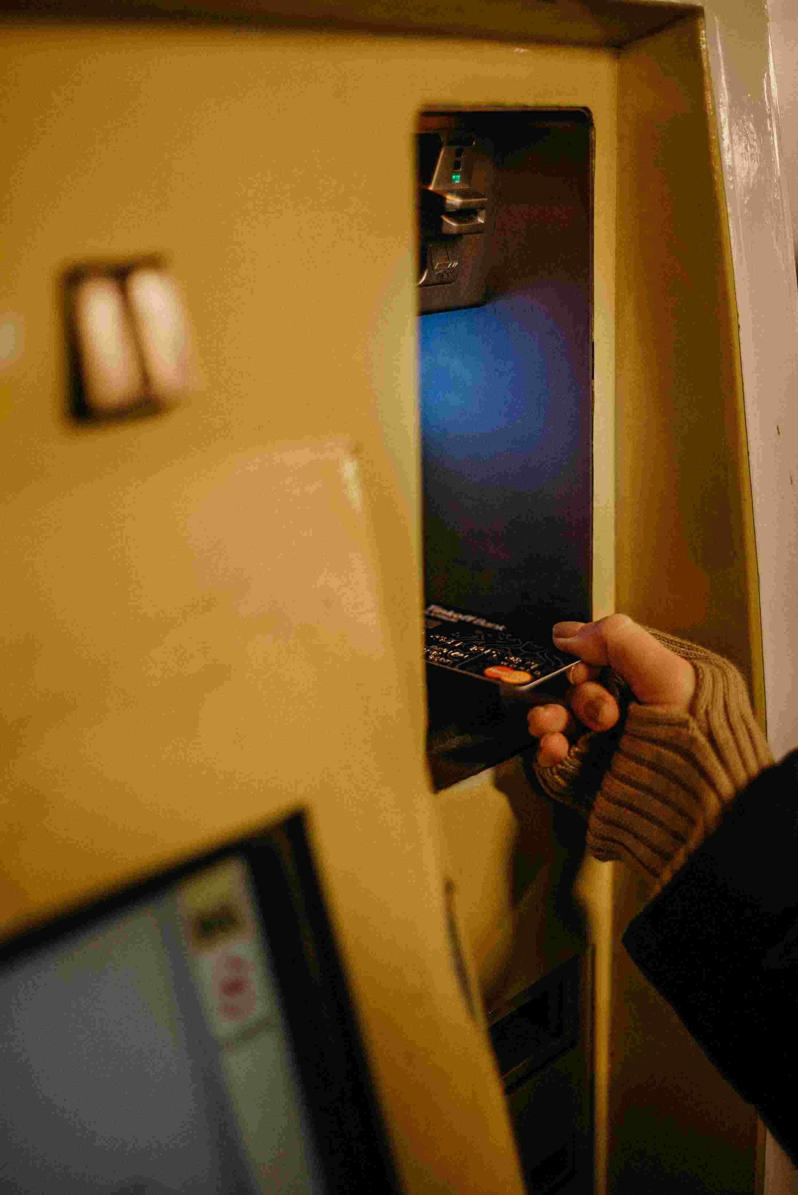 Person putting debit card in atm