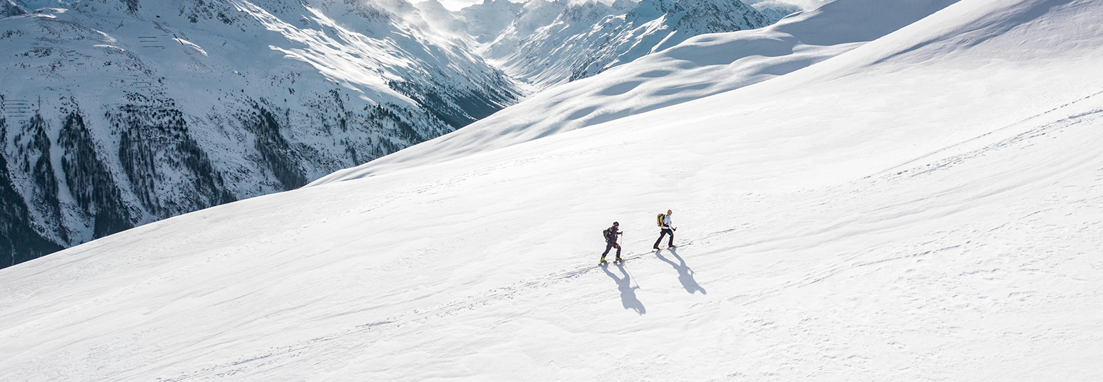 two people skiing in the mountains