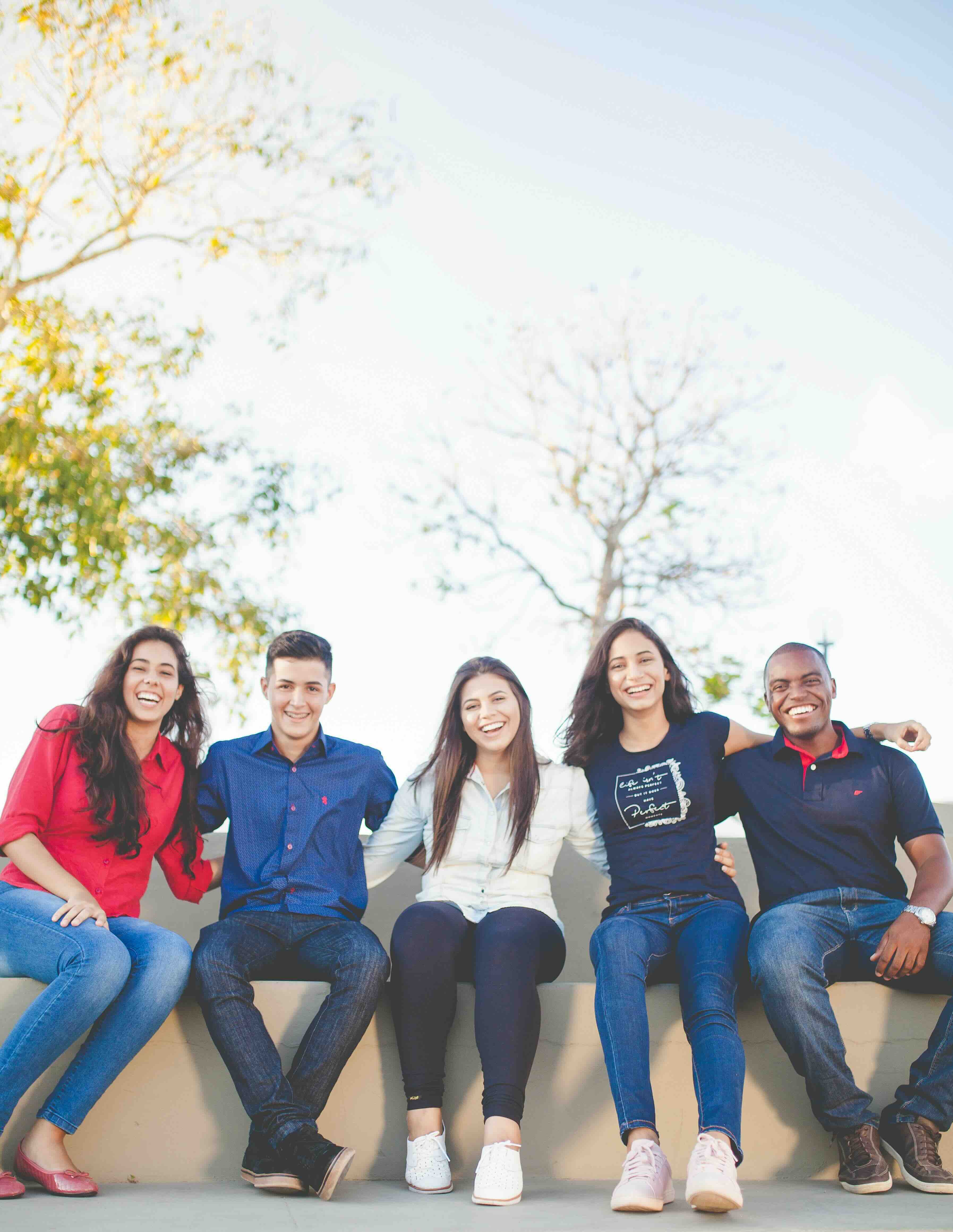 group of youth in their twenties sitting outside