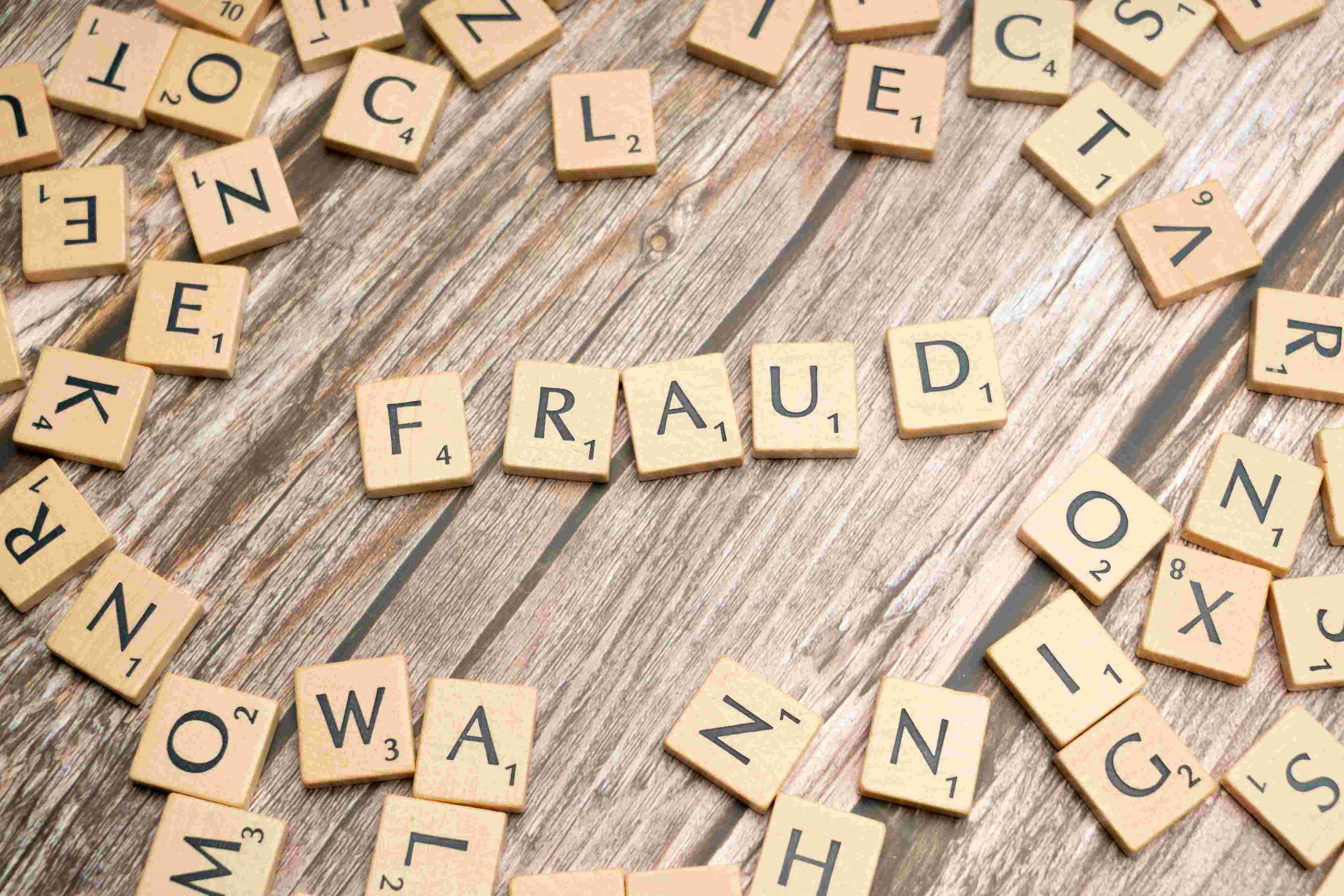 fraud spelled out in scrabble pieces